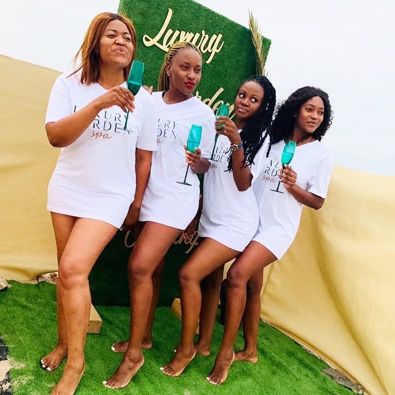 Group of guests in Luxury Garden Spa t-shirts celebrating with drinks