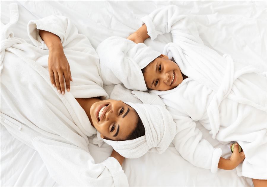 Parent and child relaxing together in spa robes