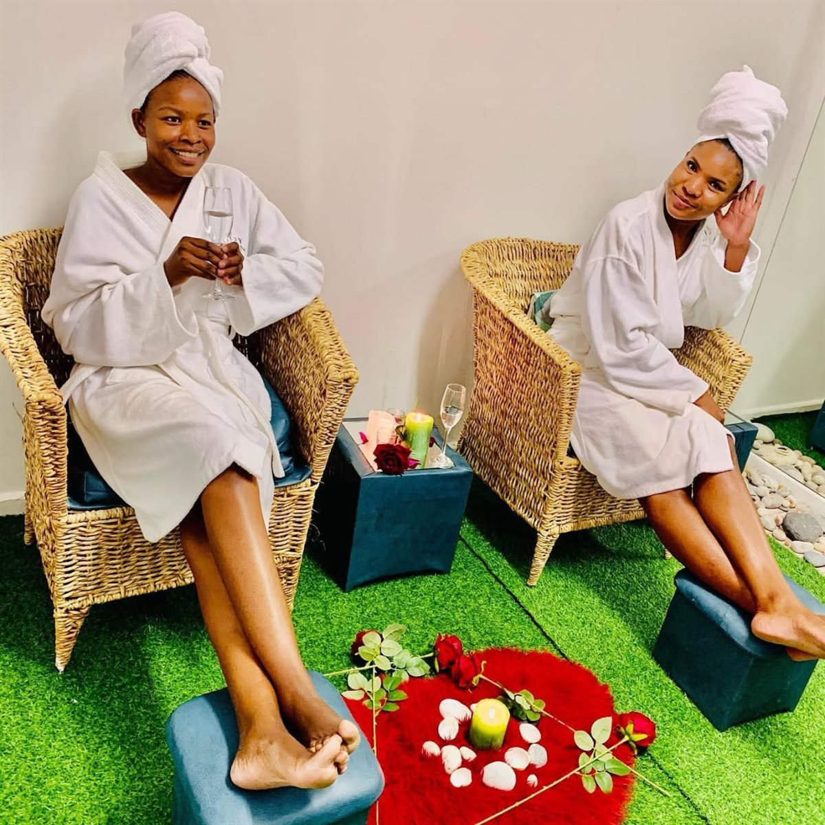 Two guests in robes relaxing together with champagne