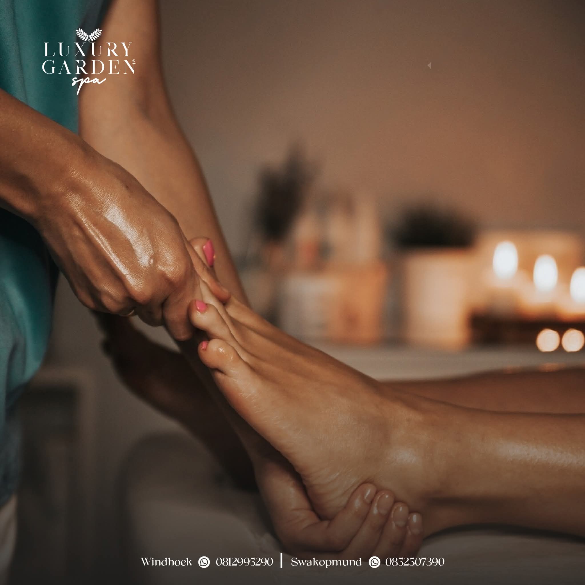 Therapist giving a candlelit foot massage